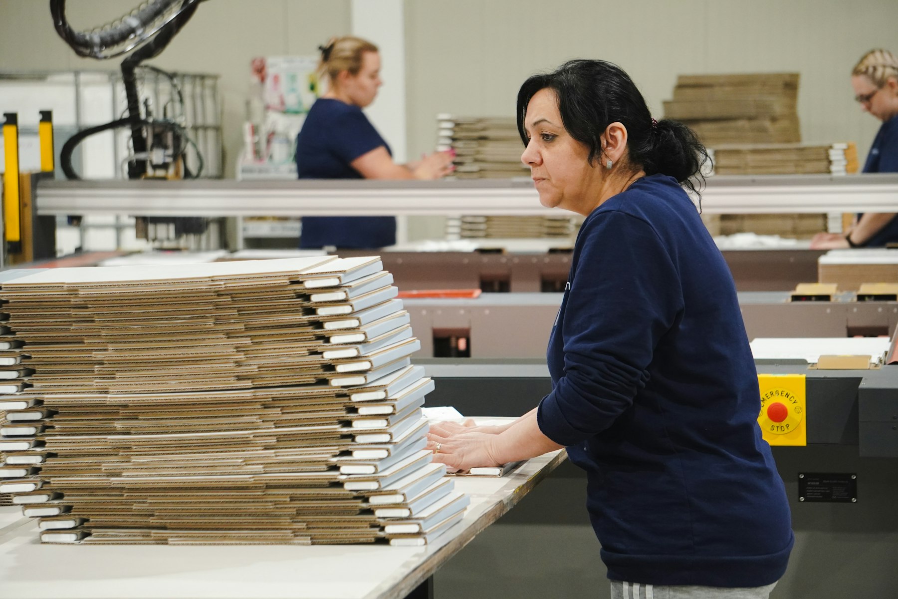 Packer preparing cartons at a fulfilment bench