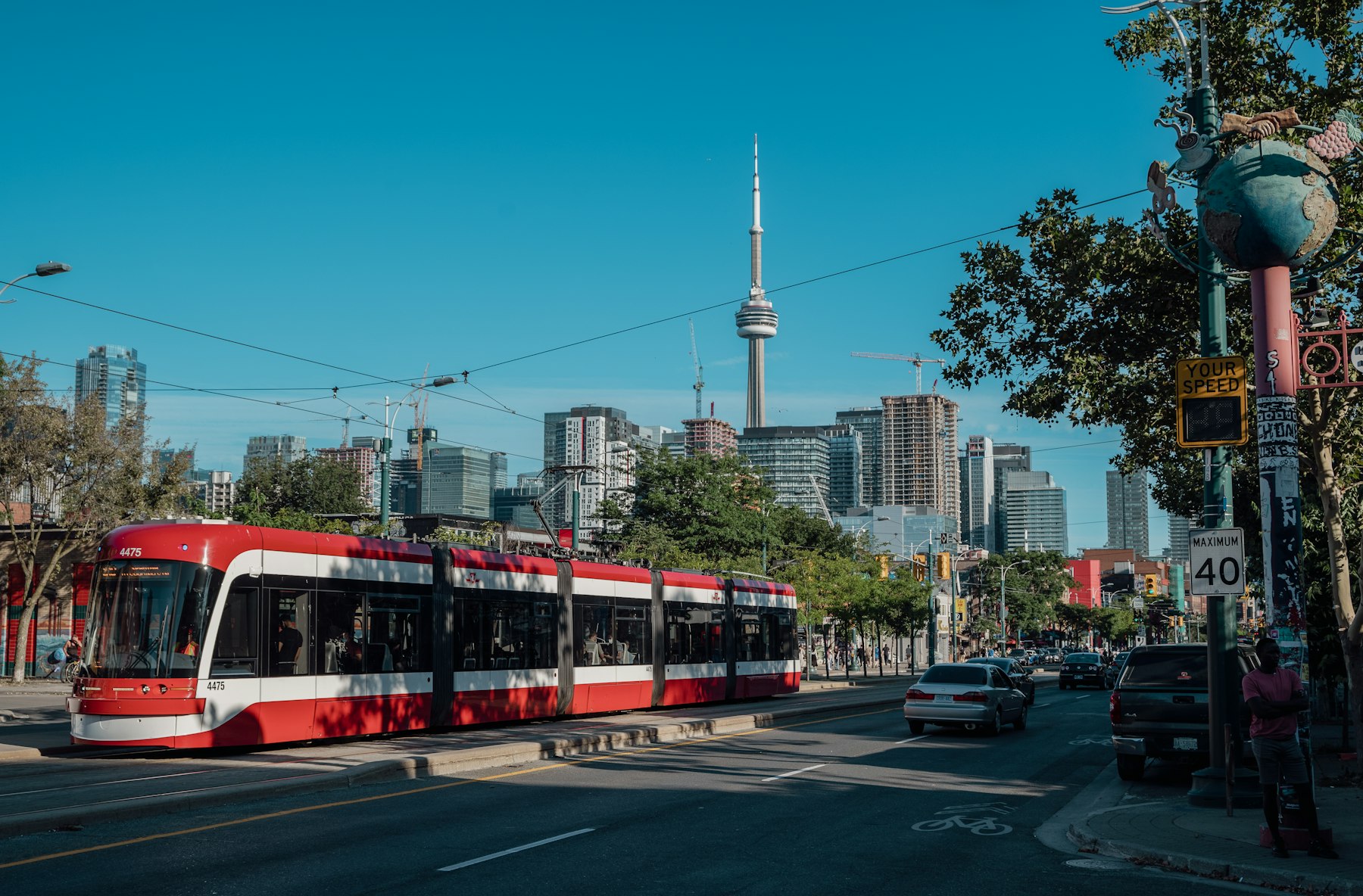 Streetcar on a downtown Toronto street with the CN Tower behind